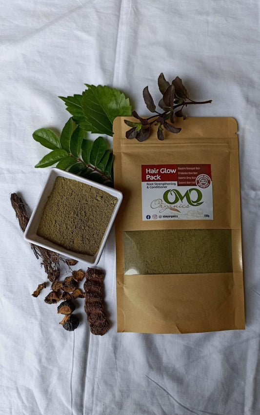 Hair Glow Pack with white background added few dry herbs and curry leaves hibiscus leaves