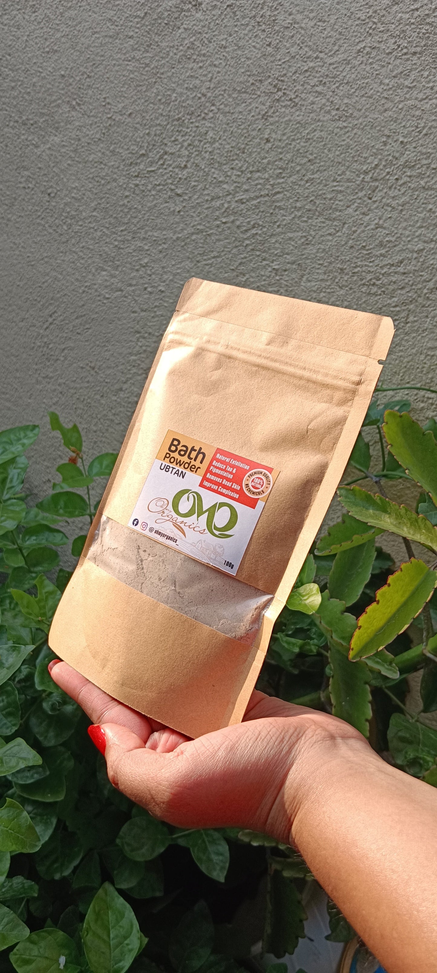 Bath Powder with background of few plants and wall