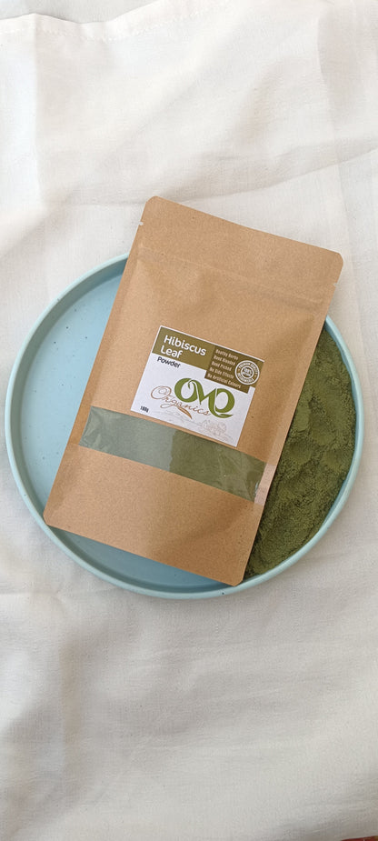 hibiscus leaf powder with white background a plate with green powder