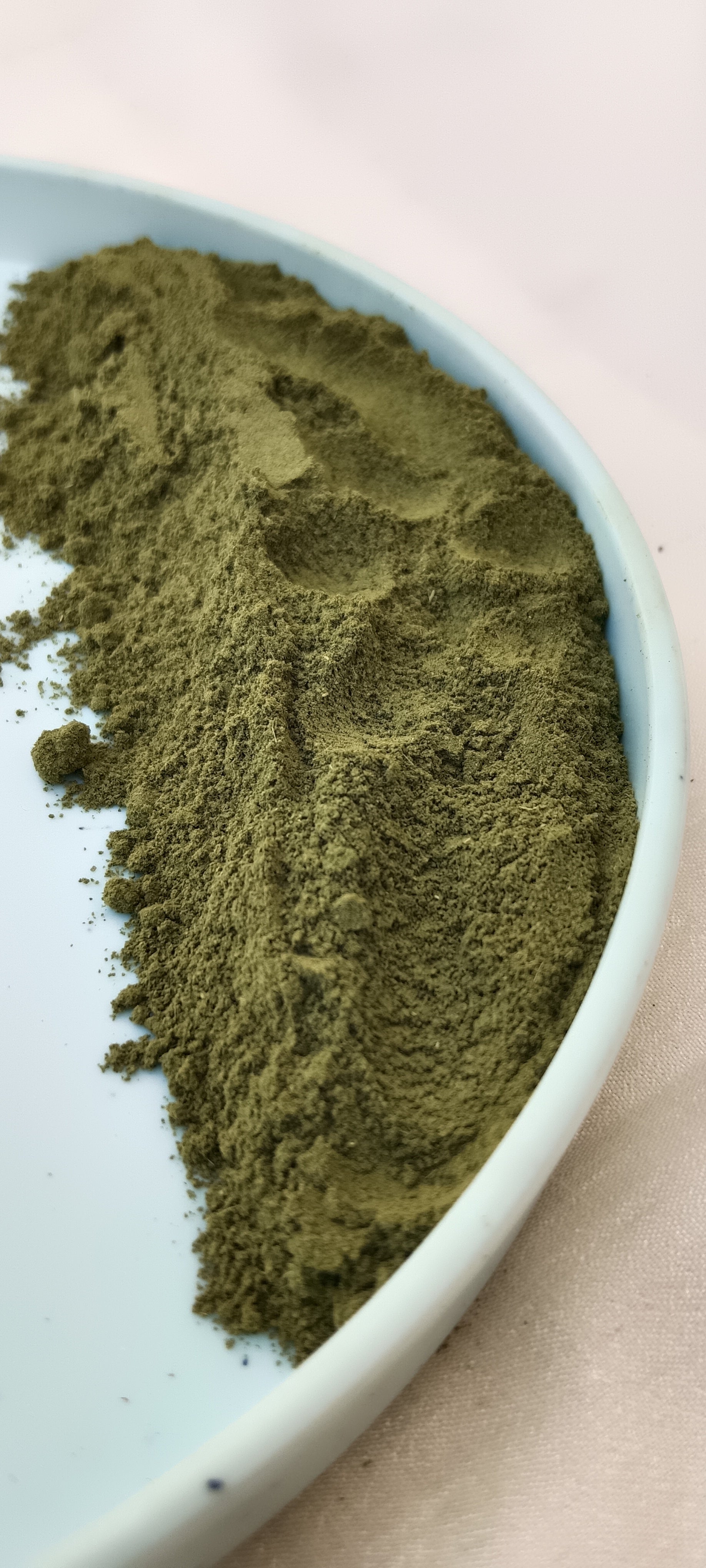 hibiscus leaf powder in a plate with white background