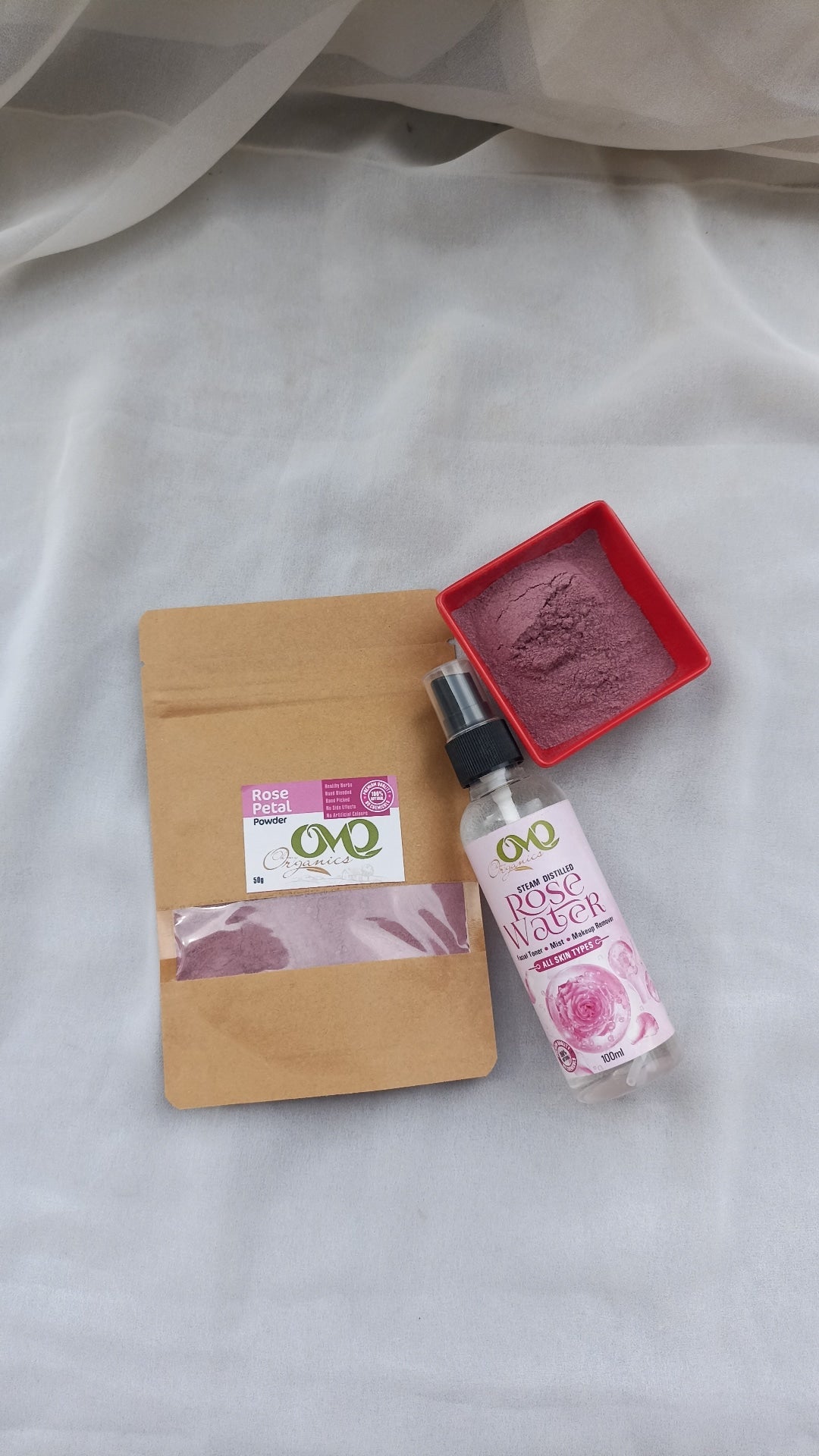 Rose Petals Powder with white background and rose water bottle